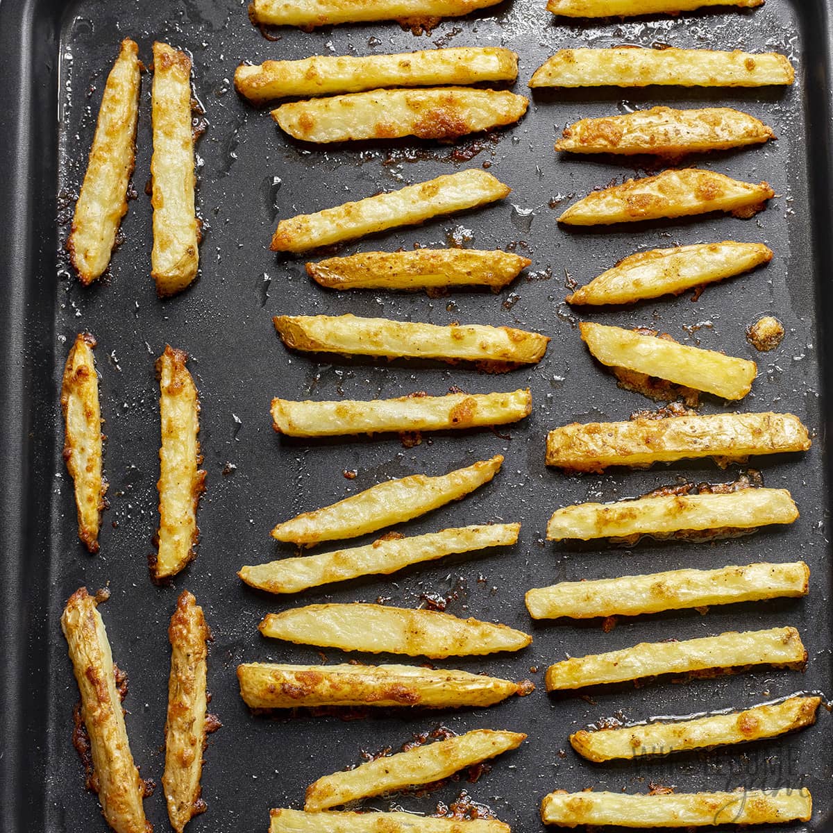 Baked garlic parmesan fries on baking sheet.