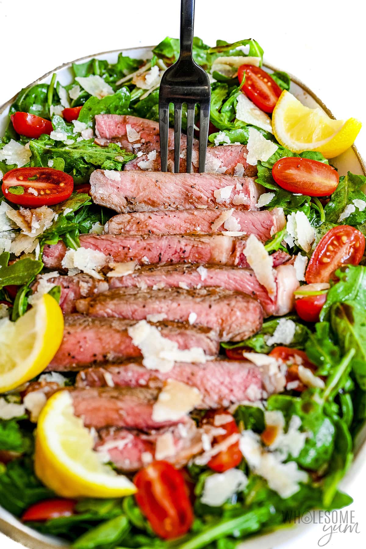 Steak salad recipe shown with fork.