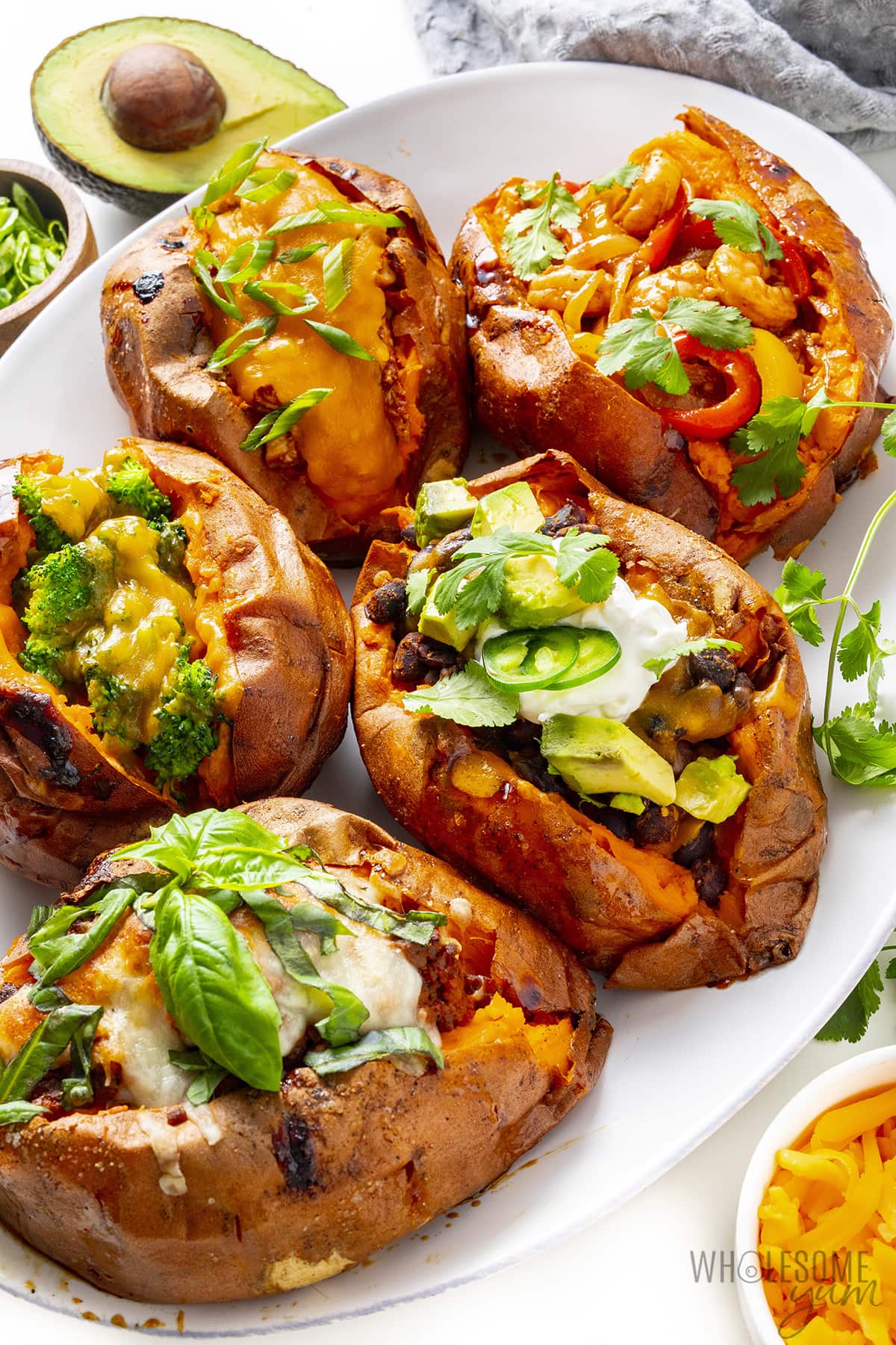 Stuffed sweet potatoes with 5 types of fillings on a platter.