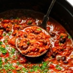 Chili recipe in a pot with ladle.