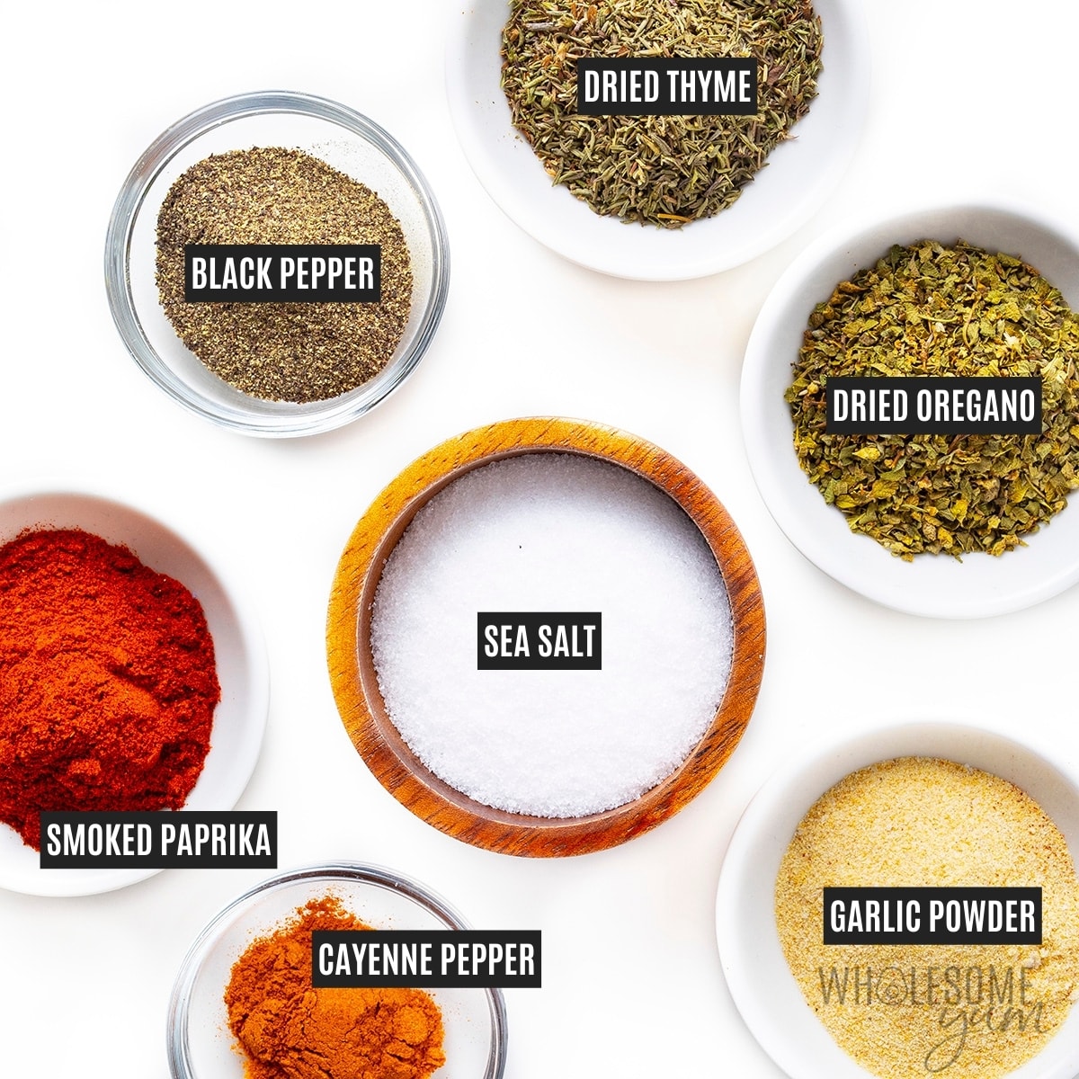 Seasonings in individual small bowls with labels.