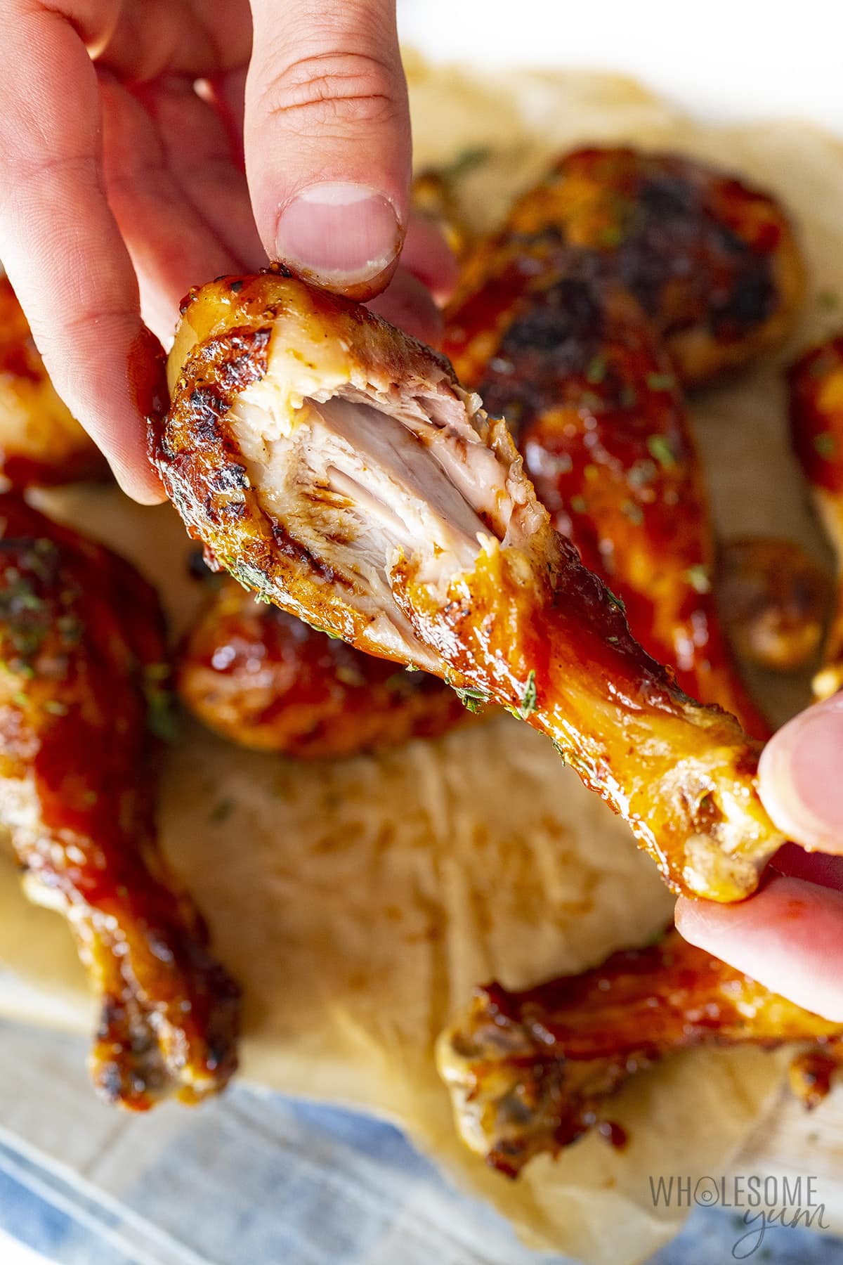 BBQ chicken legs with a bite taken out.
