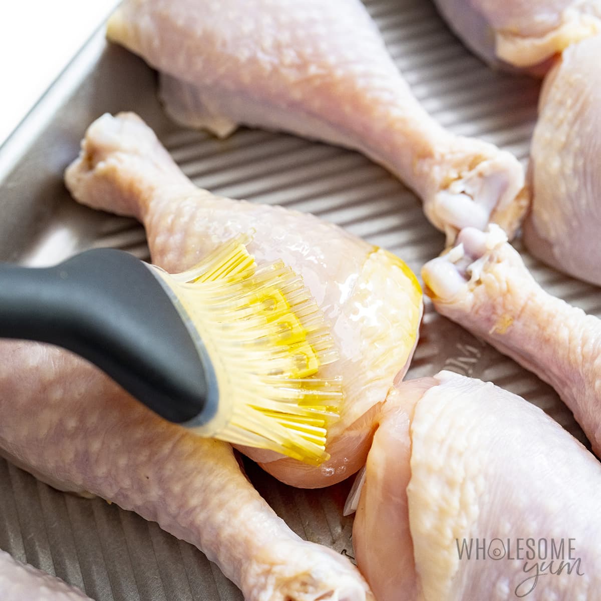 Chicken legs brushed with olive oil.