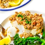 Baked haddock recipe flaked with a fork.