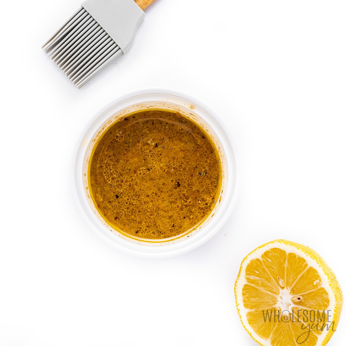 Oil, lemon juice, and seasonings whisked together in a small bowl.