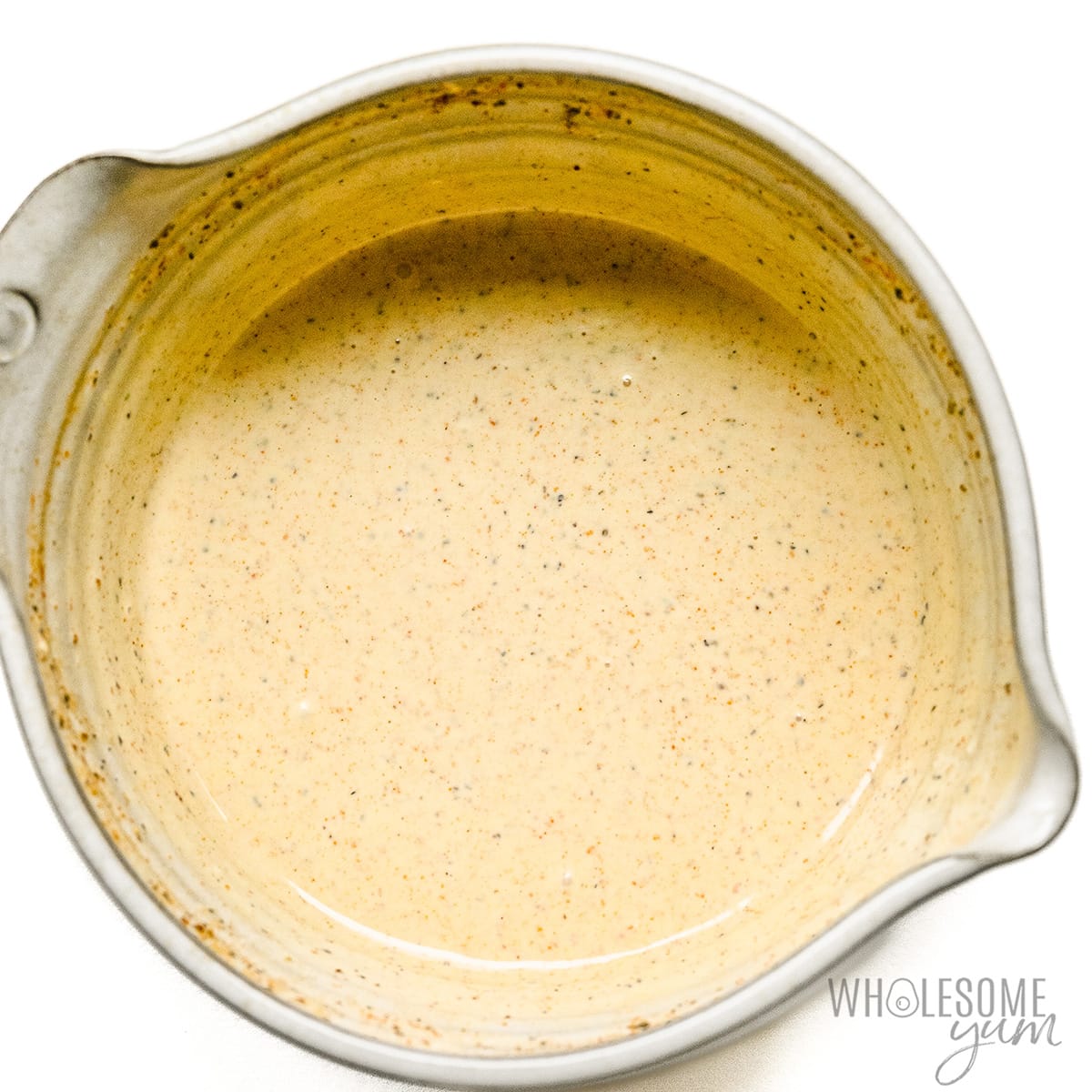 Mayo and other seasonings whisked together in a bowl.