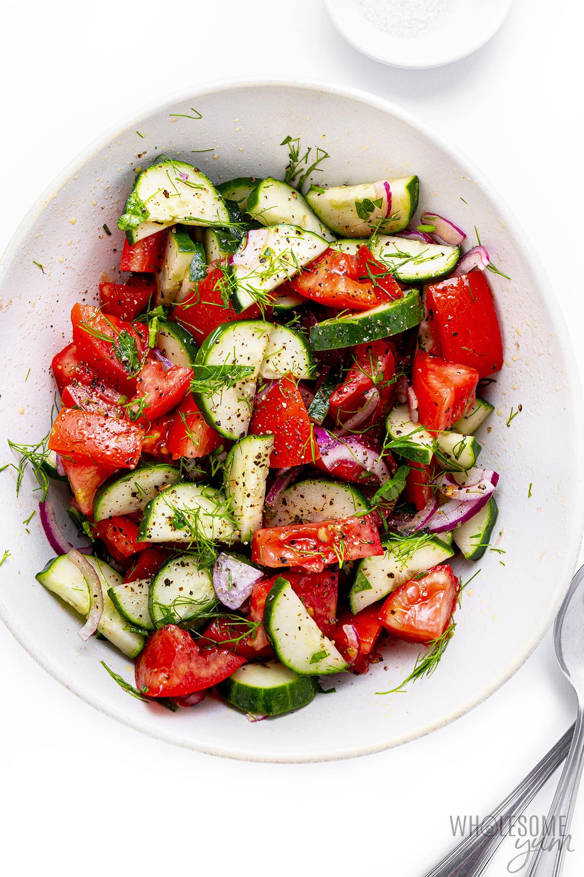 Cucumber tomato salad in a serving dish.