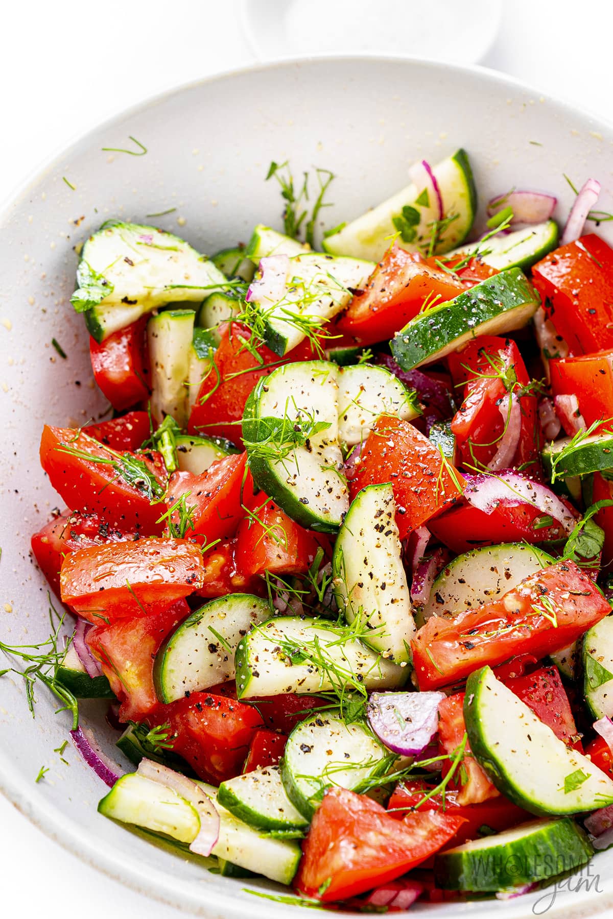 Tomato cucumber salad in a bowl.