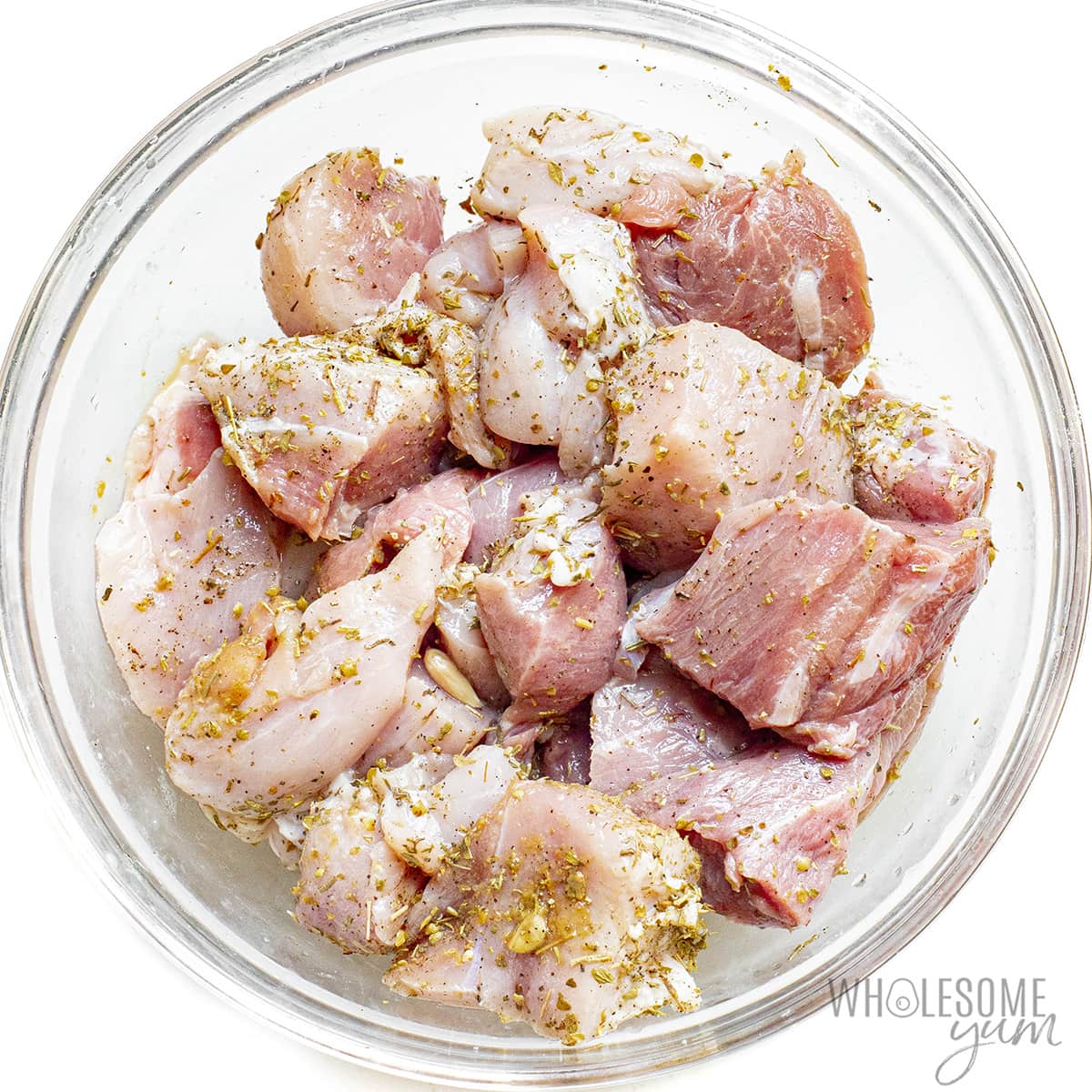 Diced pork in a bowl with seasonings.