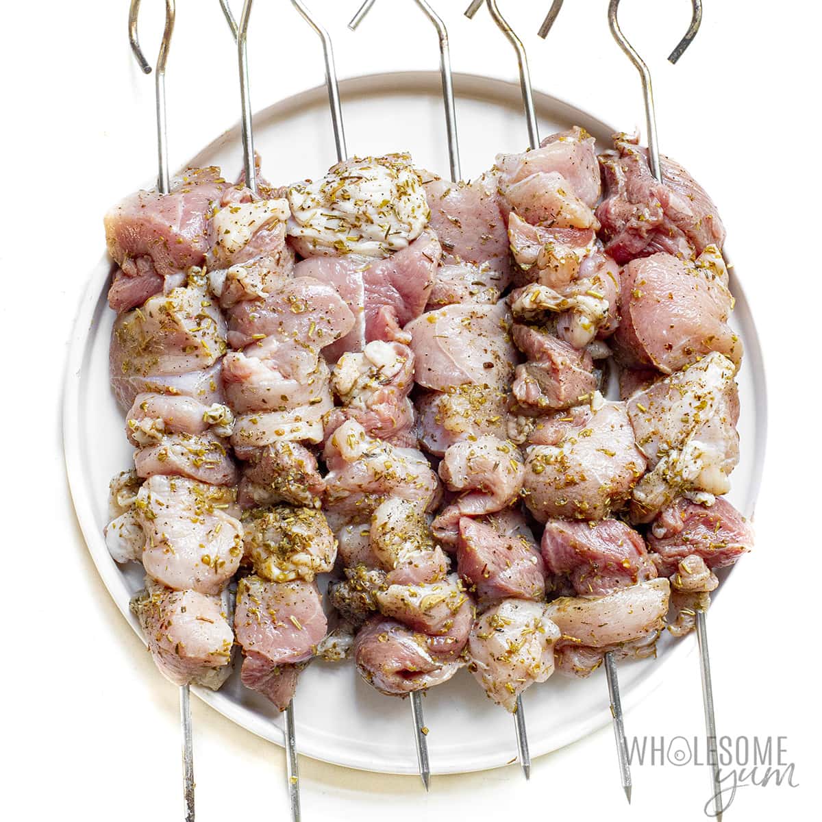 Pork pieces placed on skewers.