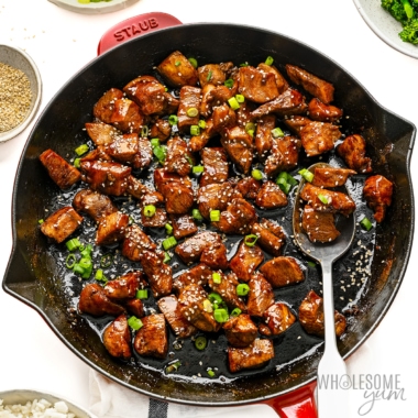 Teriyaki chicken garnished with sesame seeds and green onions.