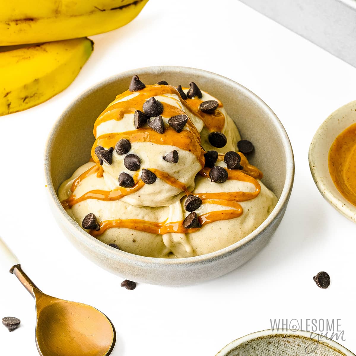 Banana ice cream drizzled with peanut butter and topped with chocolate chips.