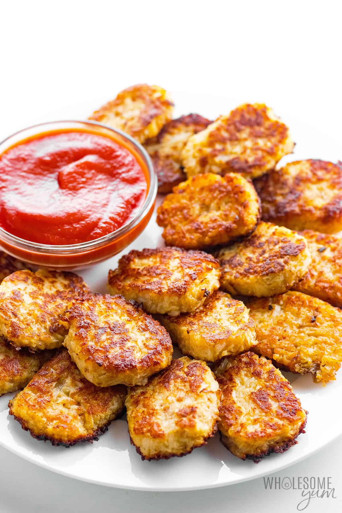 Crispy cauliflower tots on a serving platter with ketchup.
