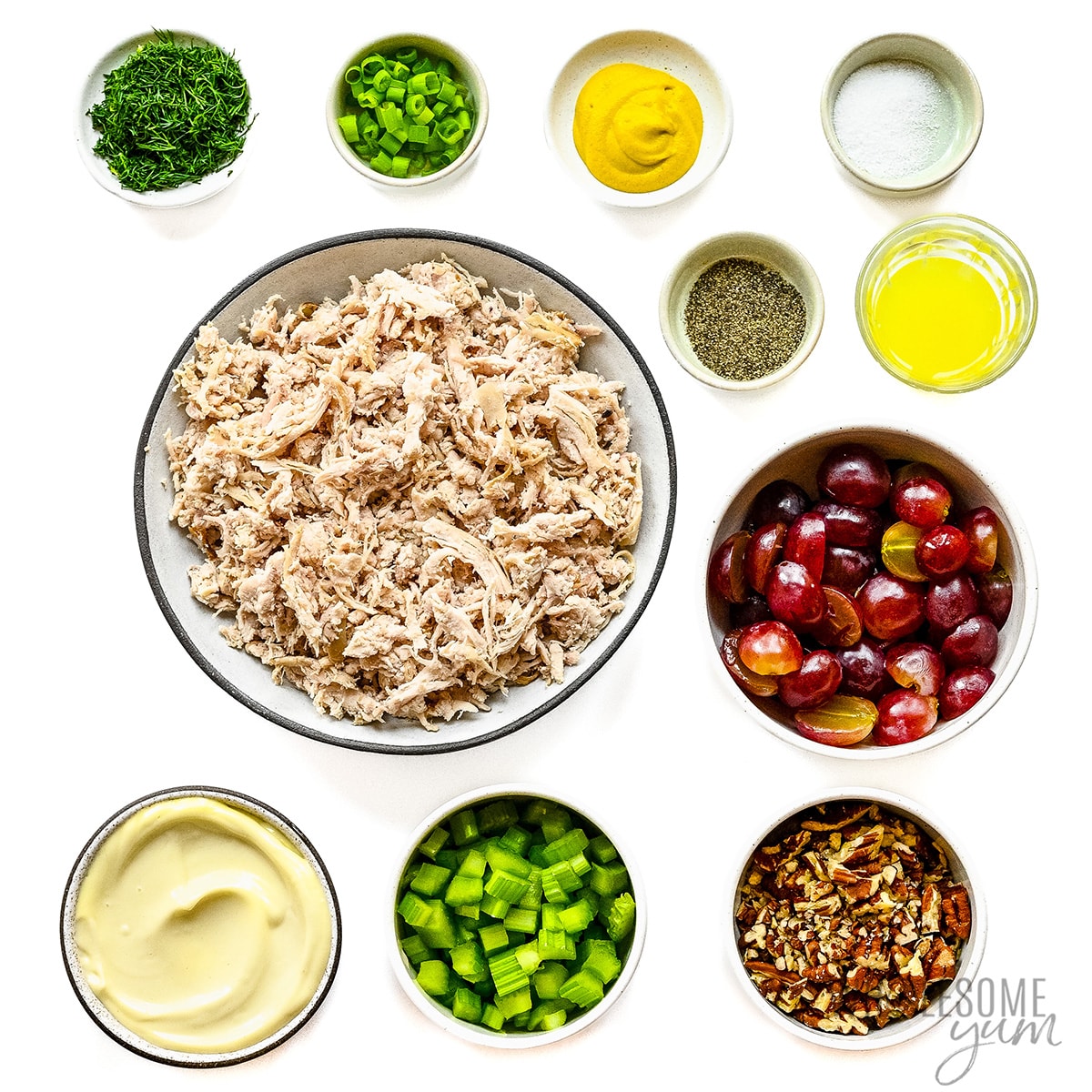 Chicken salad ingredients measured in bowls.