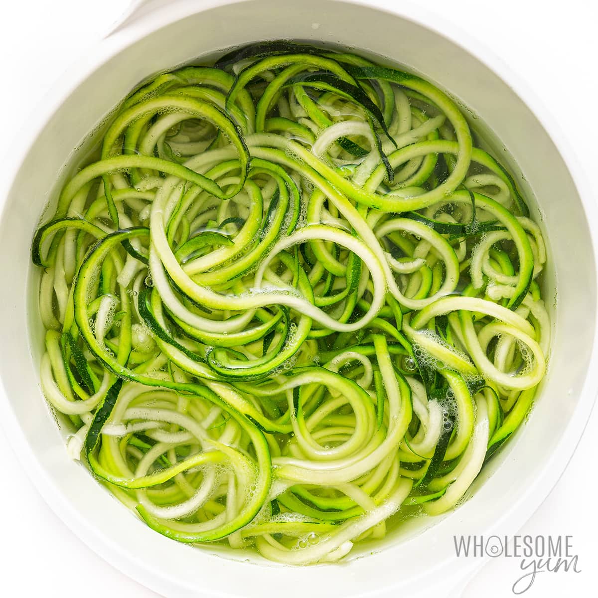 Zucchini noodles in pot of water.