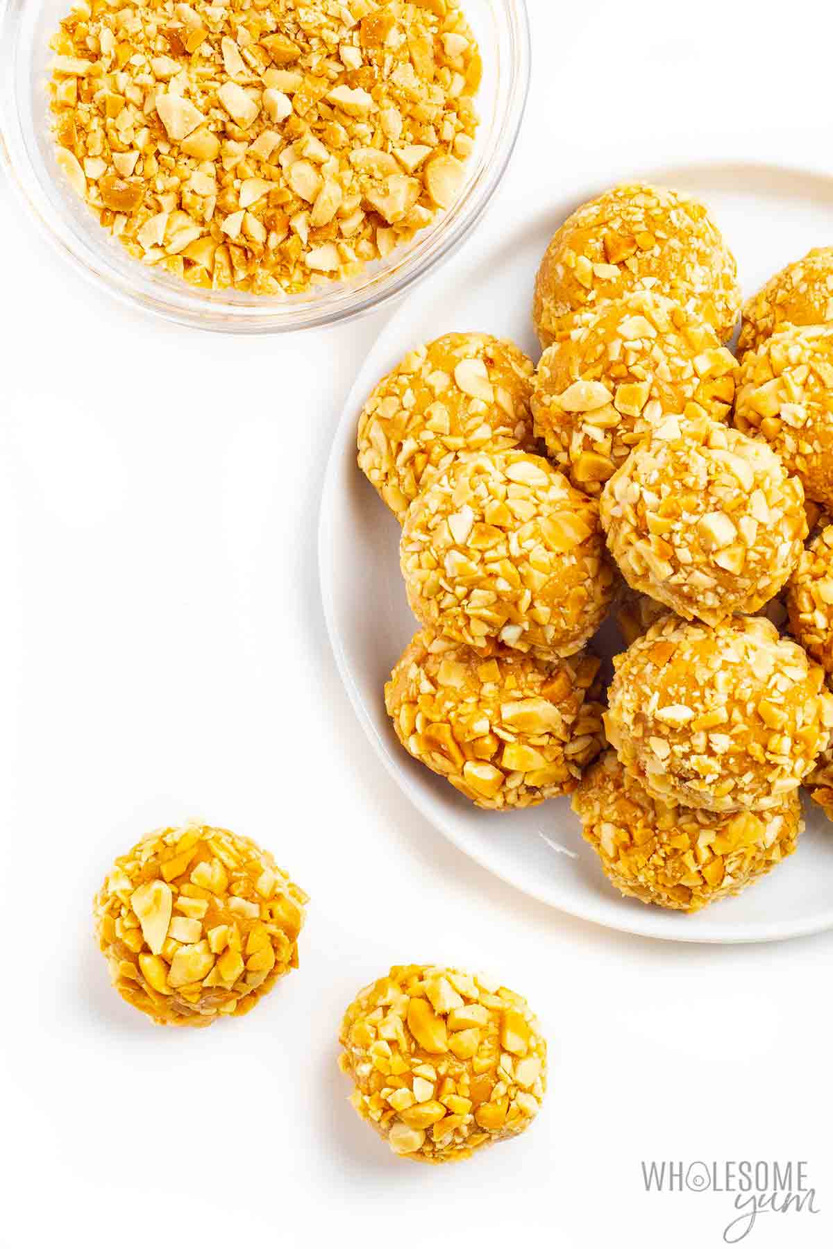 Protein balls spread out on counter and on a dish.