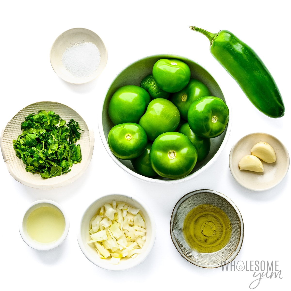 Salsa verde recipe ingredients measured in bowls.