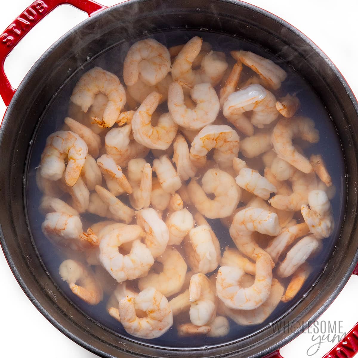Shrimp being cooked in a pot of water.