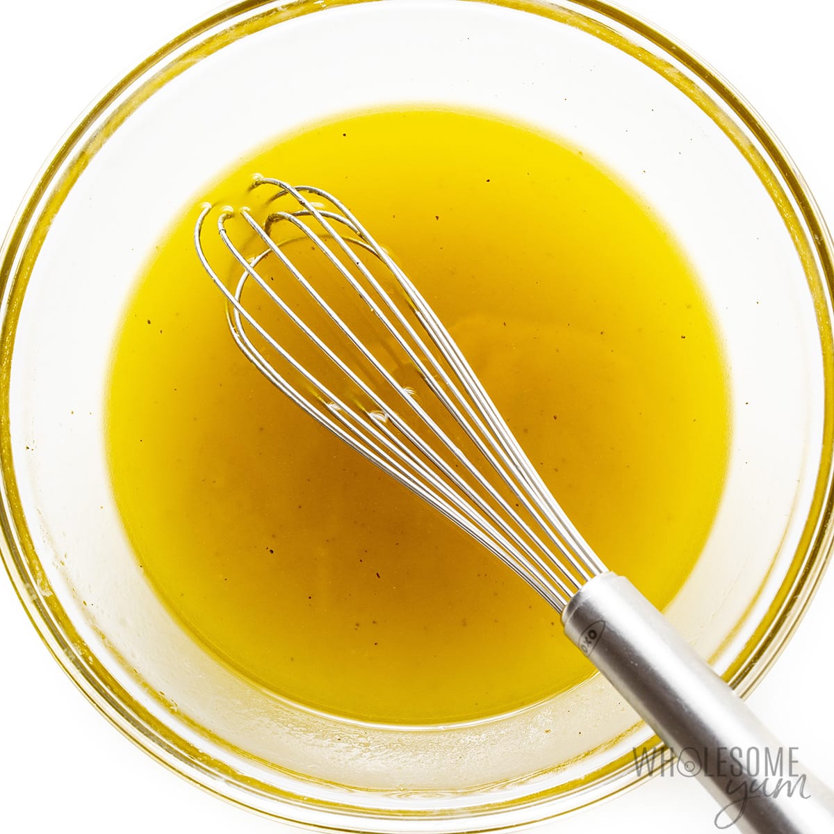 Olive oil, vinegar, sugar-free honey, salt, and pepper whisked together in bowl.