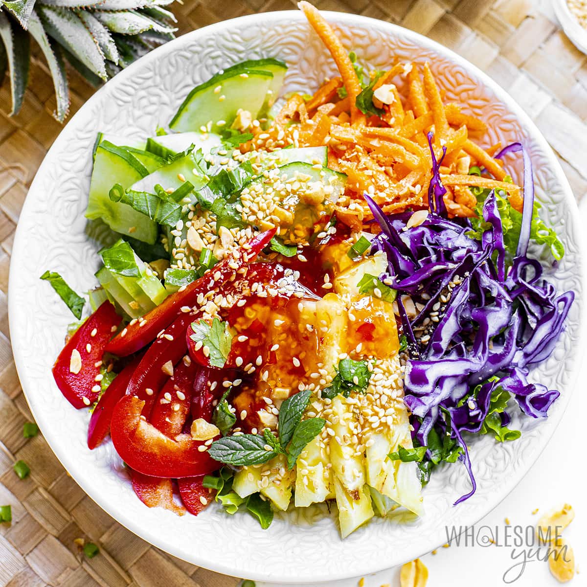 Thai peanut salad drizzled with dressing.