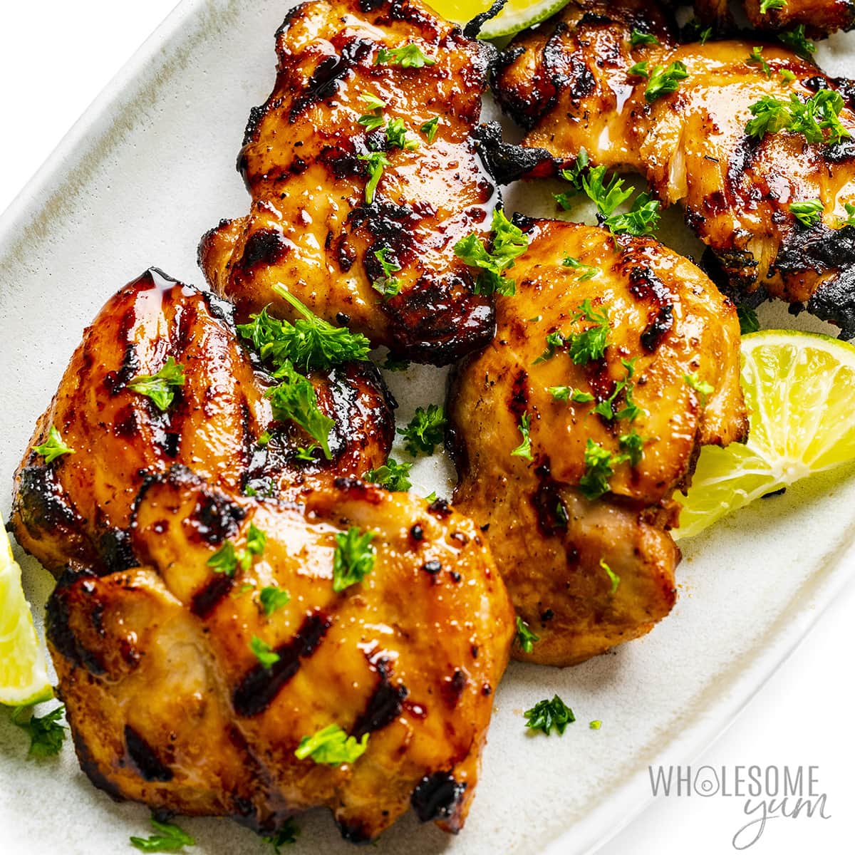 Boneless grilled chicken thighs plated.