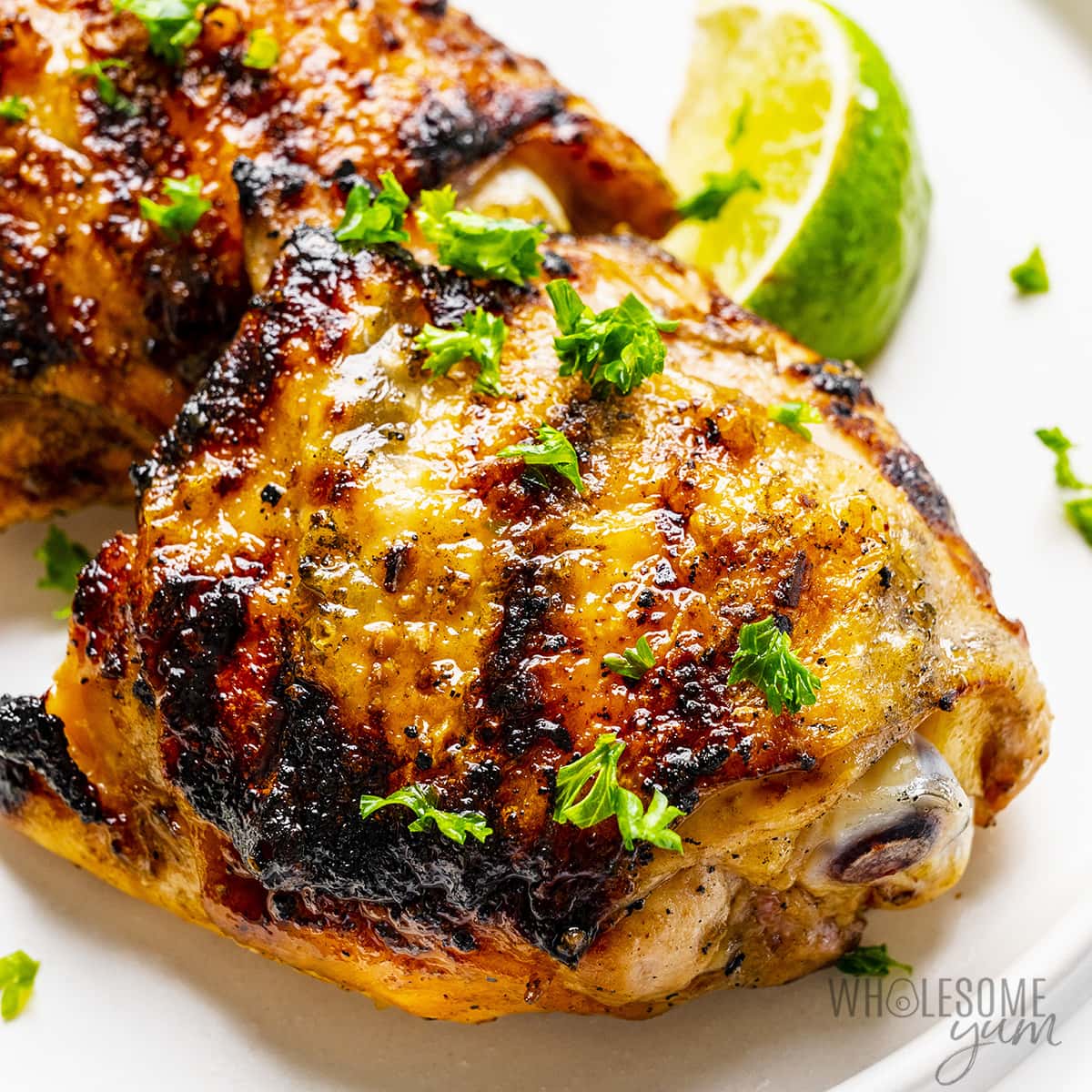 Grilled chicken thighs close up.