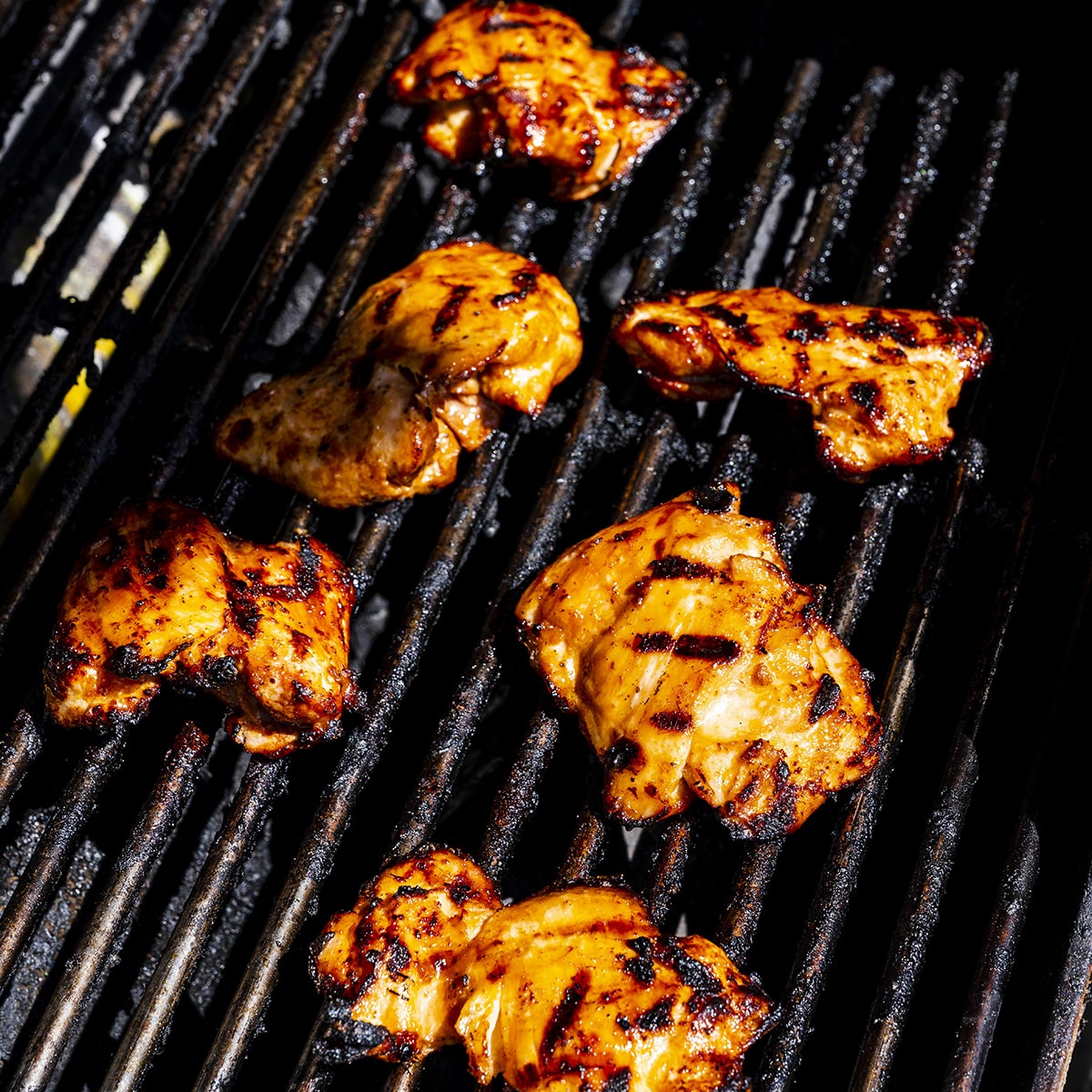 Boneless chicken thighs on the grill.