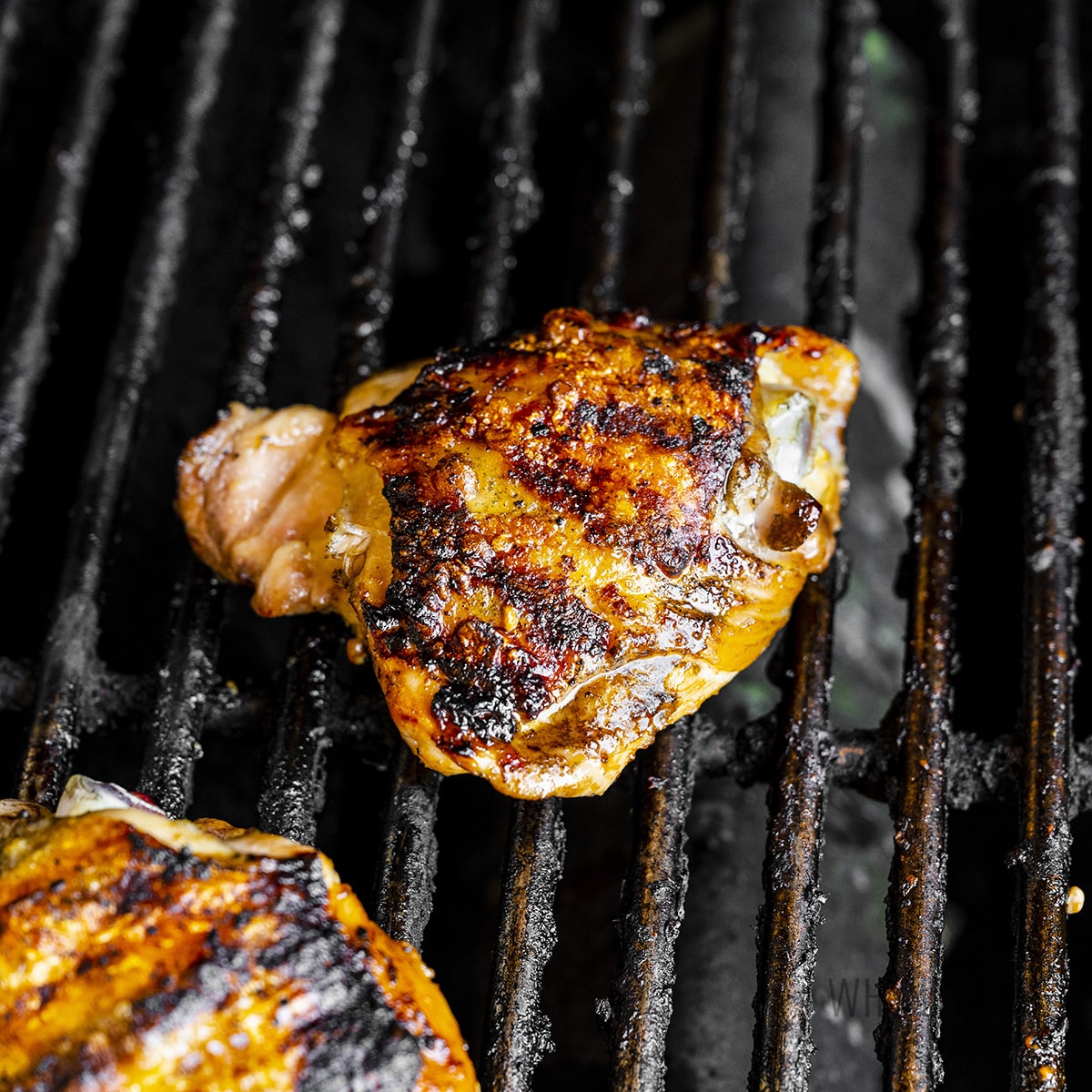 Bone-in chicken thighs on the grill.