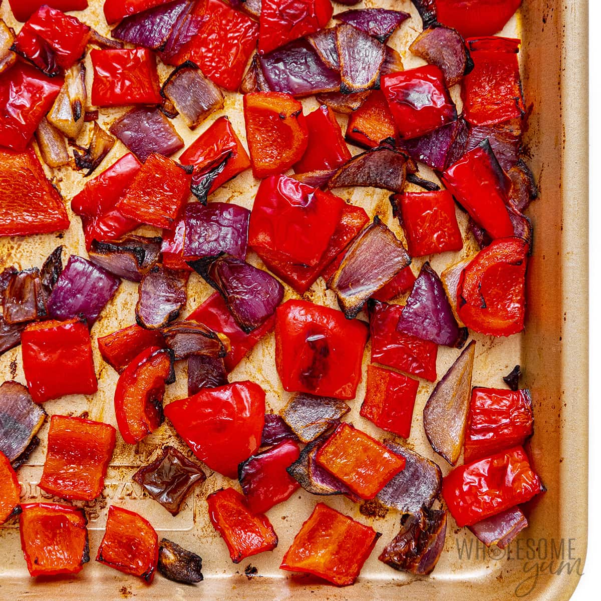 Roasted peppers and onions on a sheet pan.