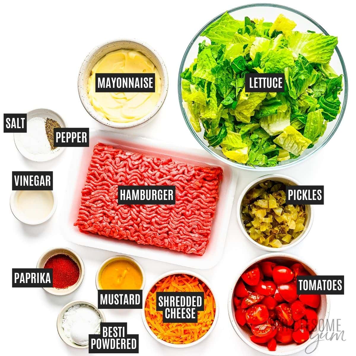 Lettuce, ground beef, and other recipe ingredients in individual bowls.