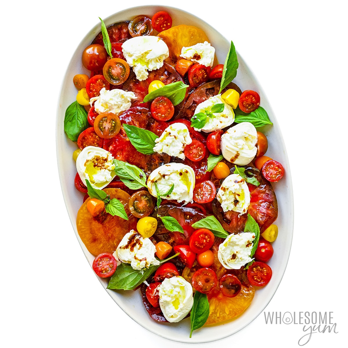 Tomatoes, cheese, and basil in a serving platter.