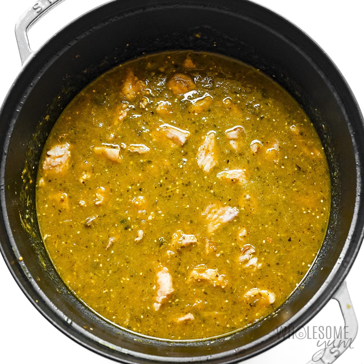 Pork chile verde thickened in pot.