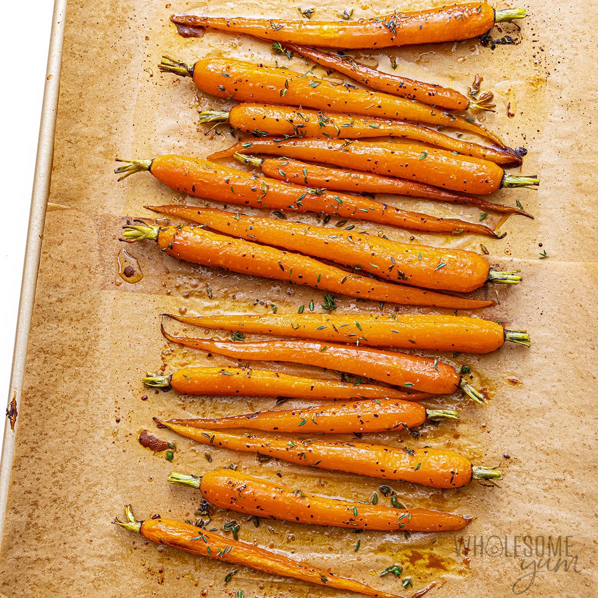 Honey roasted carrots on a sheet pan.