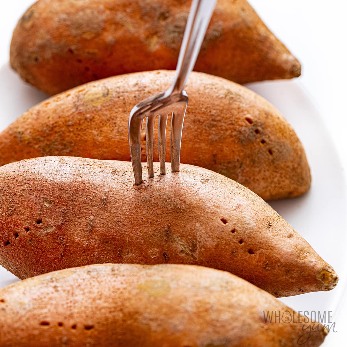 Poke holes in the sweet potatoes with a fork.