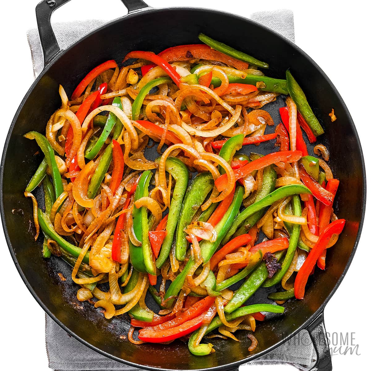 Bell peppers and onions in skillet.