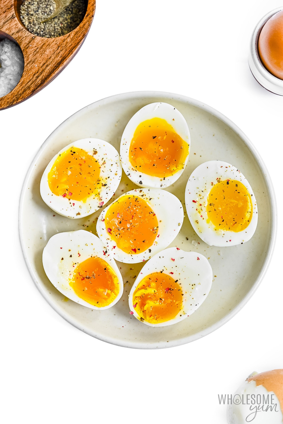 Perfect soft boiled eggs cut in half on a plate.