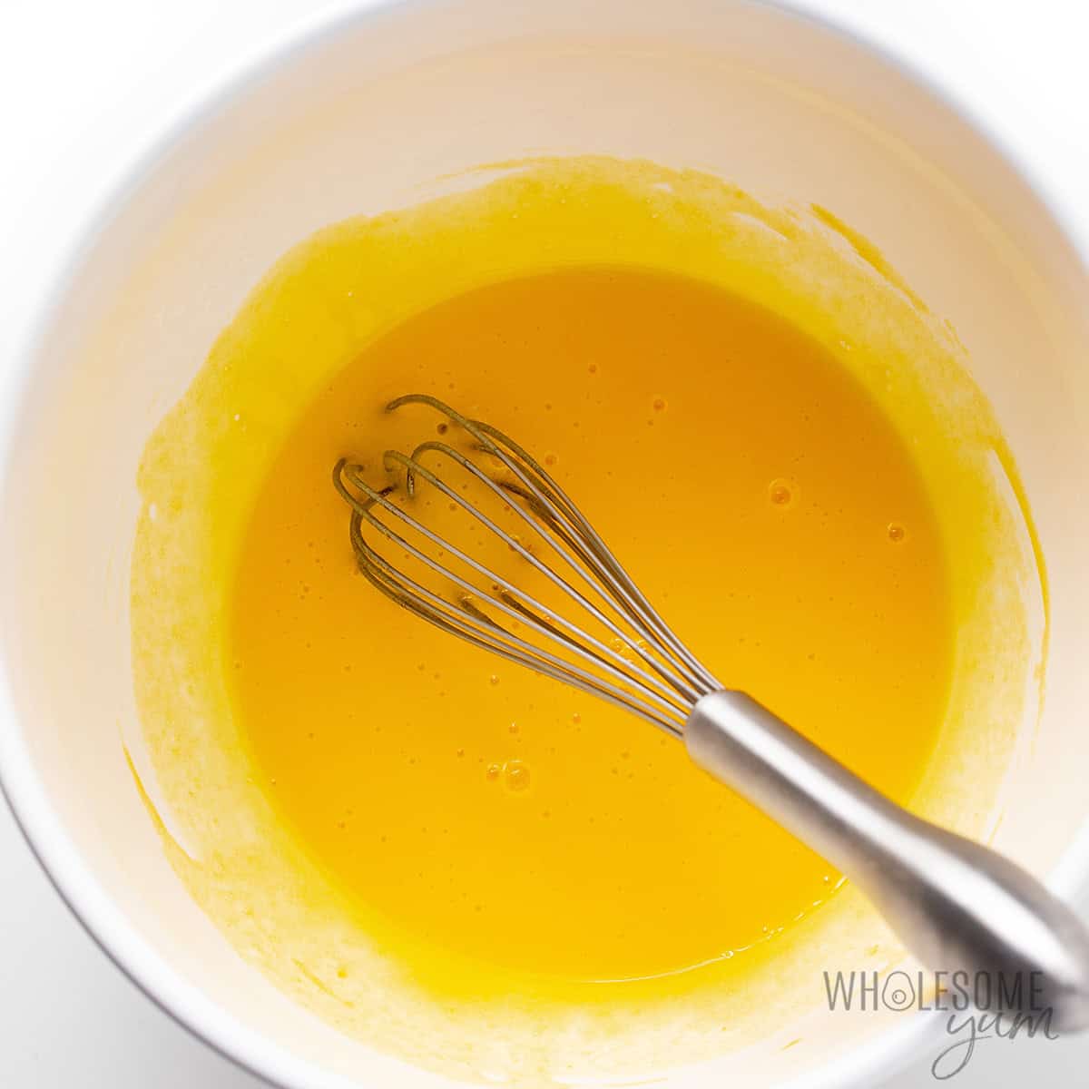 Whisking egg yolks in a bowl.