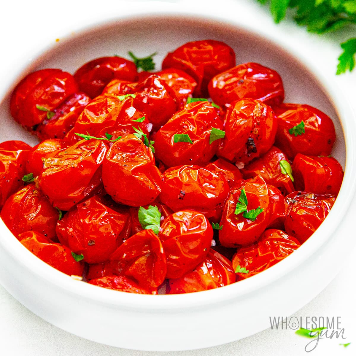 Roasted cherry tomatoes in a bowl.