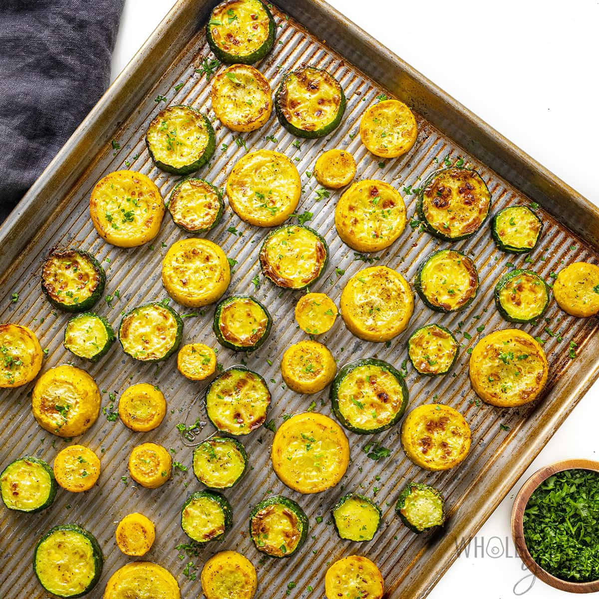 Roasted zucchini and squash on a baking sheet.