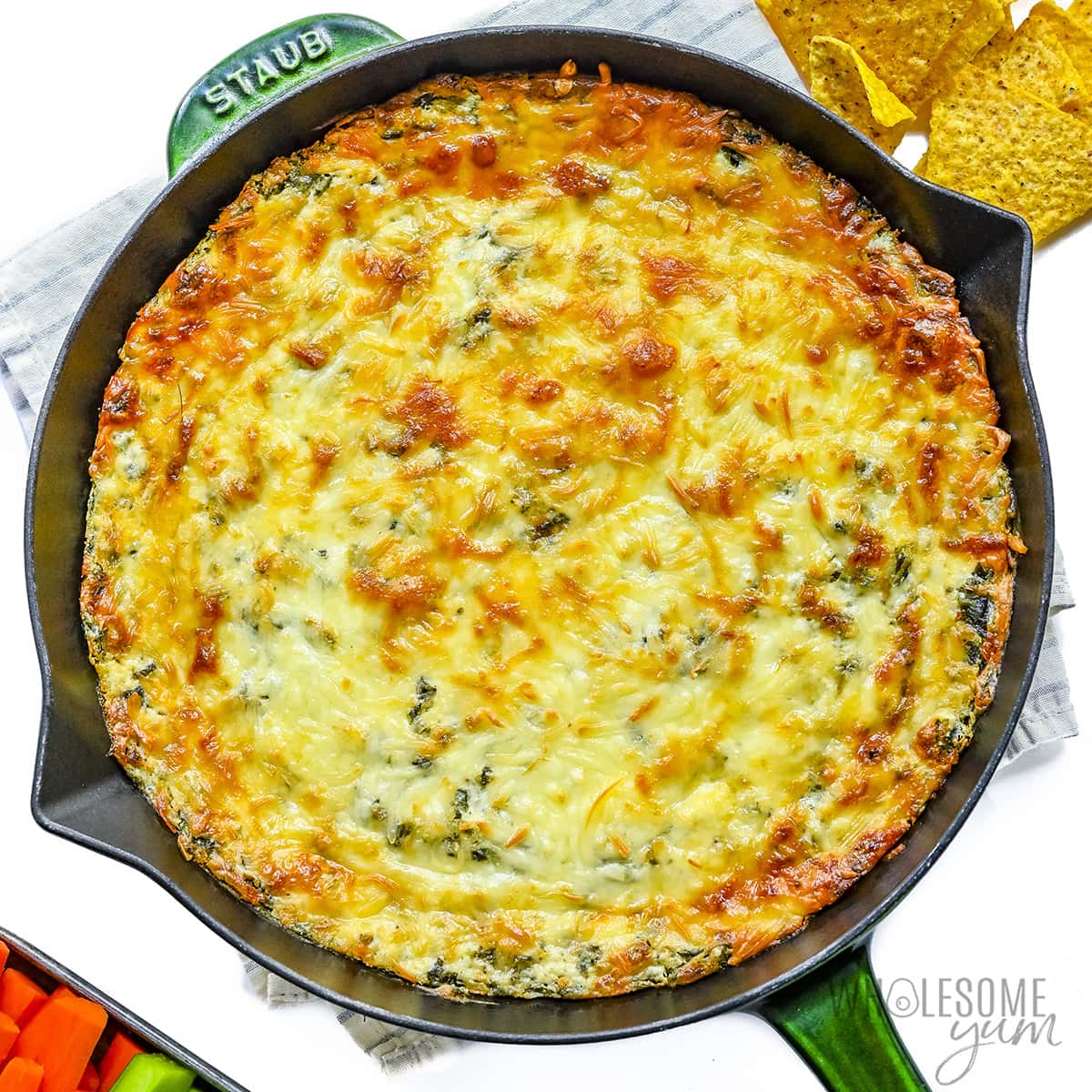 Baked spinach dip in a cast iron skillet.