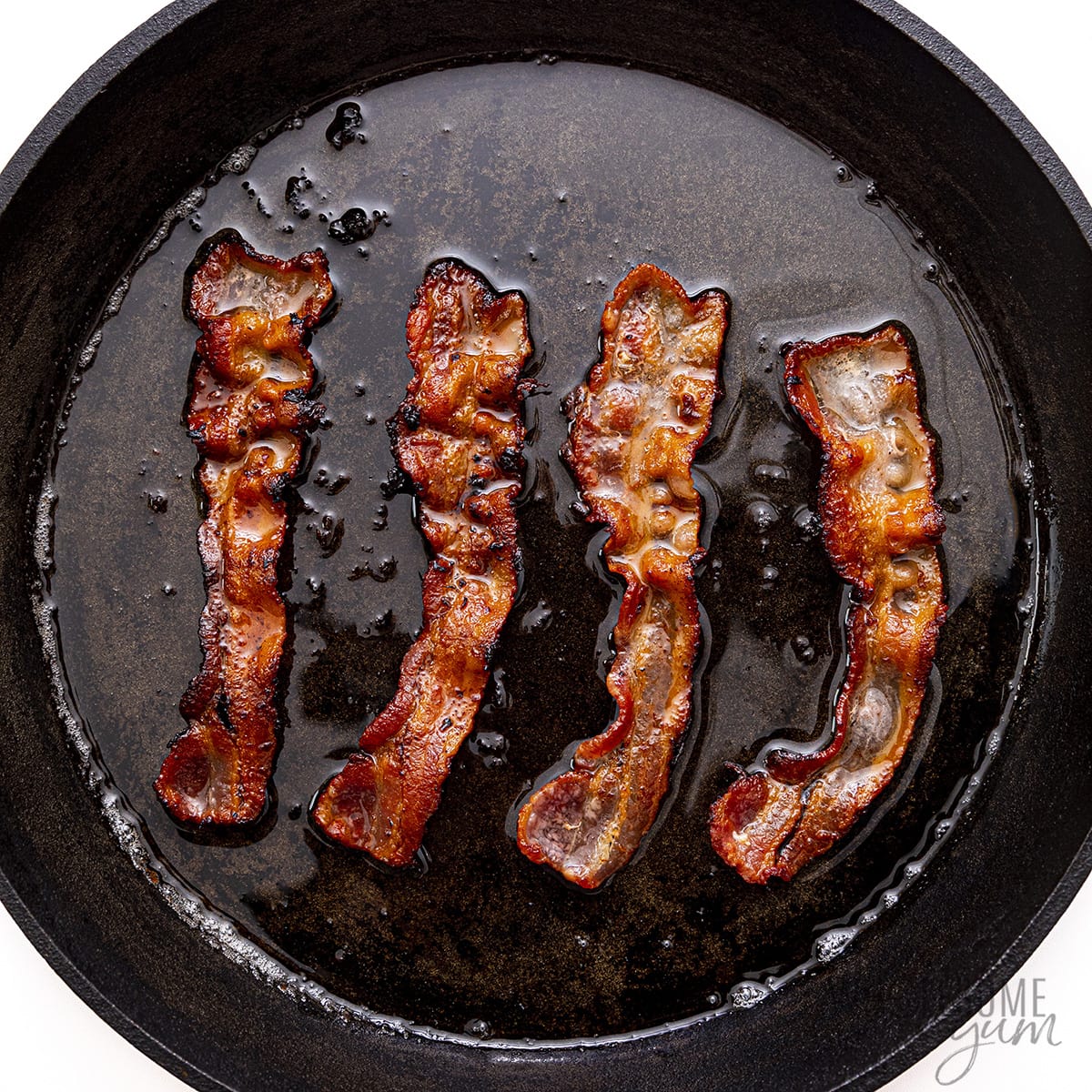 Bacon cooked in a skillet.