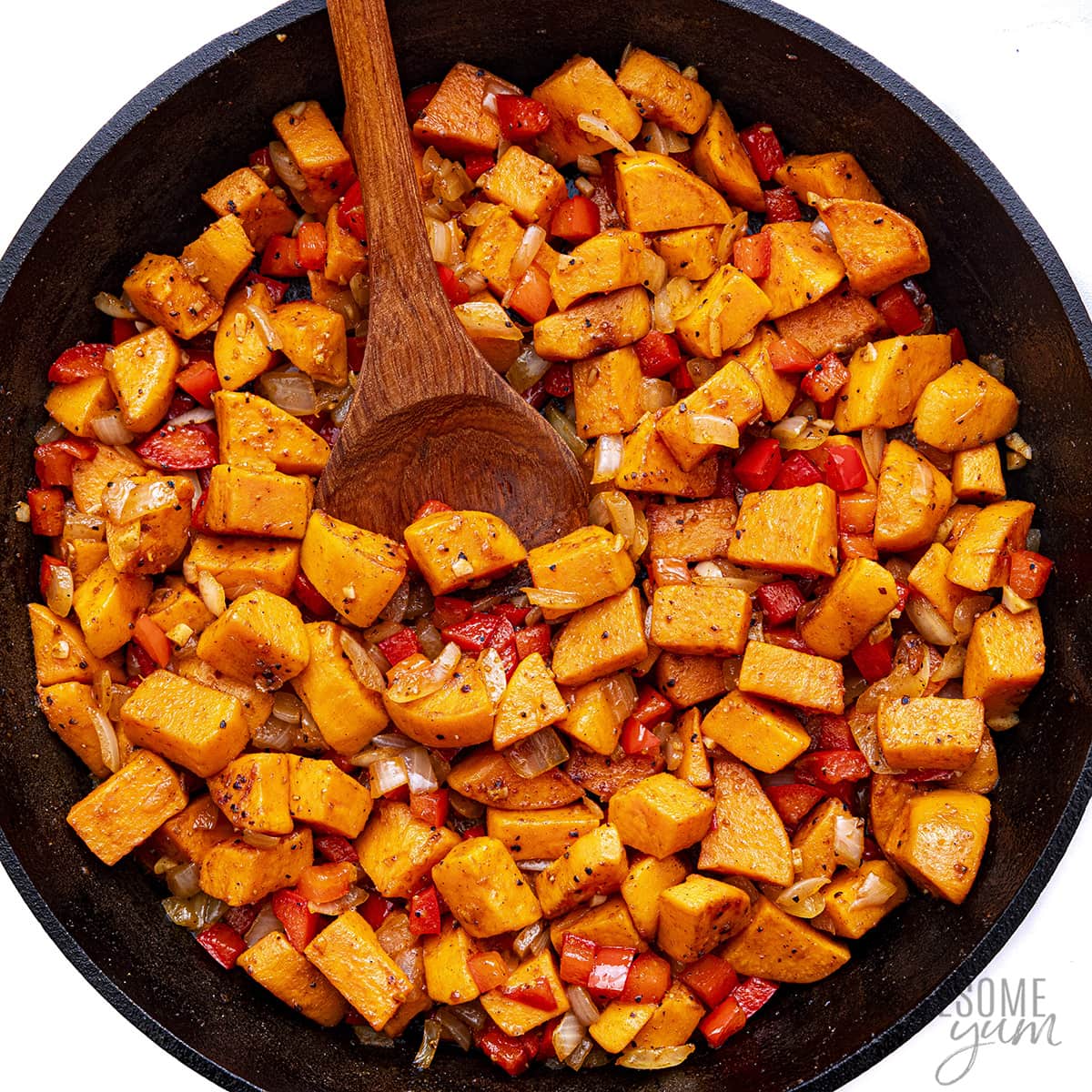 Red pepper, onion, and garlic cooked with sweet potatoes.