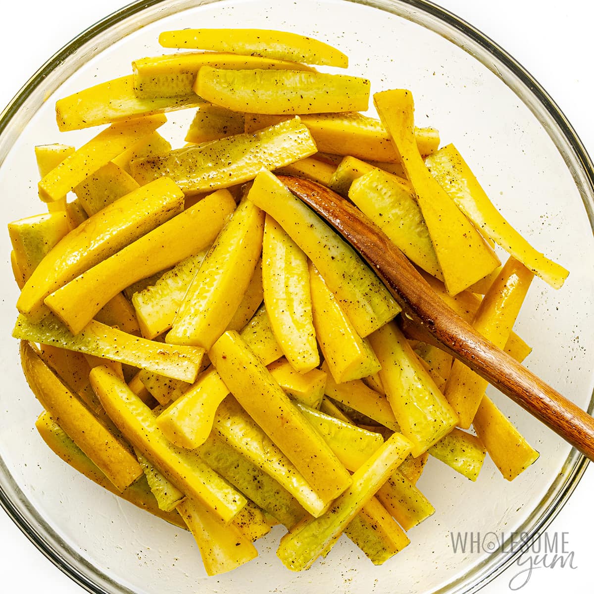 Seasoned strips of squash in a bowl.
