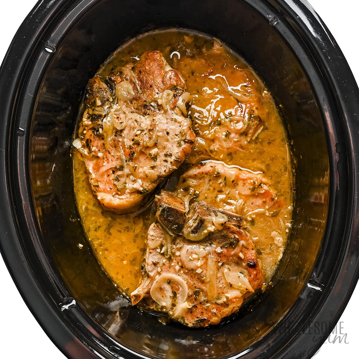 Cooked pork chops in the Crock Pot.