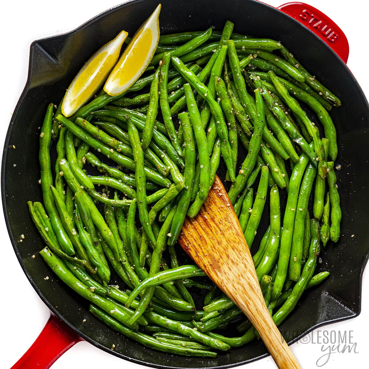 Add the lemon slices to the skillet and sauté the green beans.