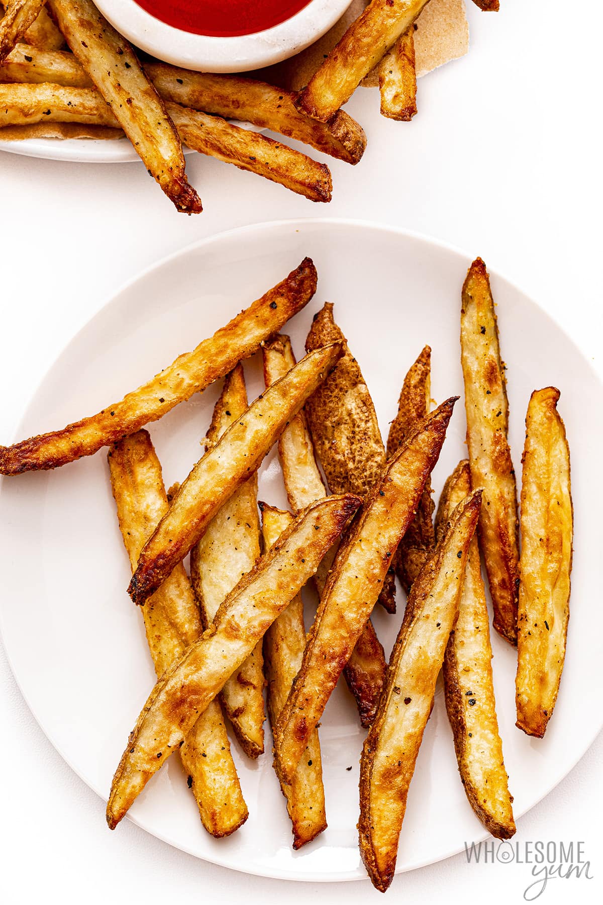 Air fryer french fries on two plates.