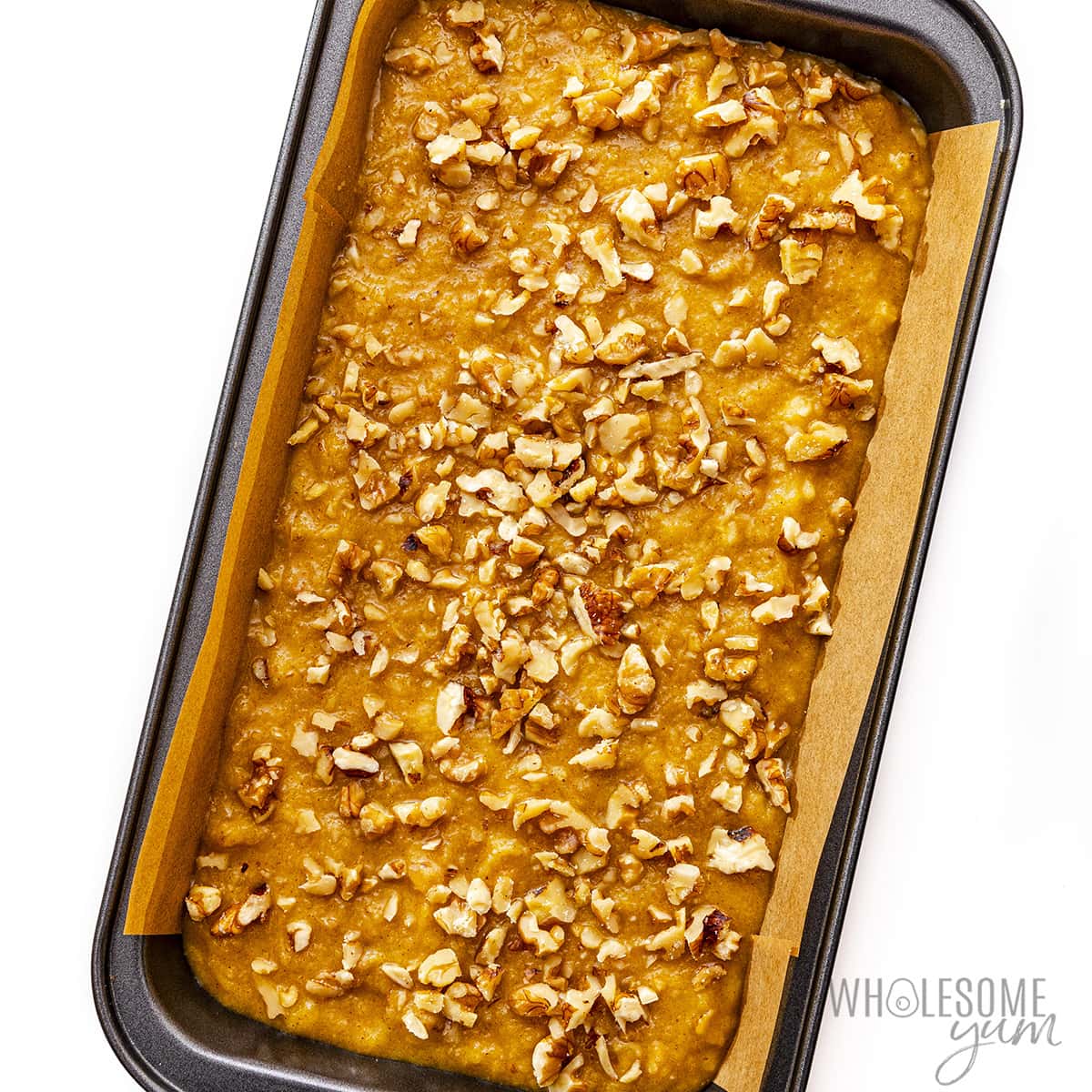 Pour the almond flour banana bread batter into the loaf pan.