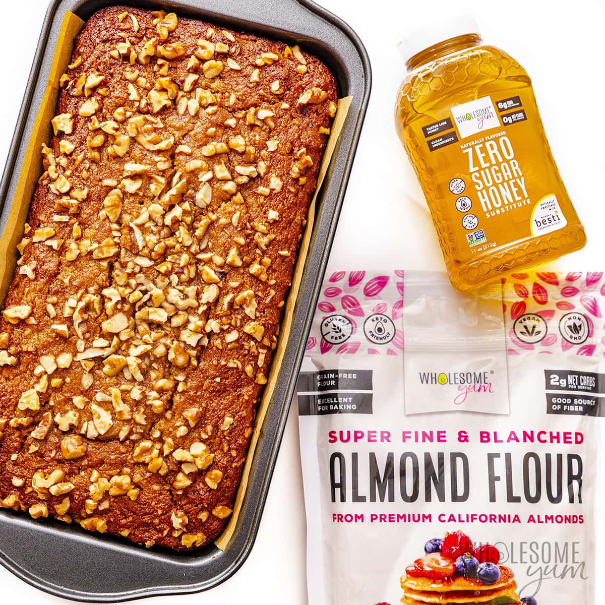 Gluten-free banana bread with a bag of almond flour and a bottle of zero-sugar honey.