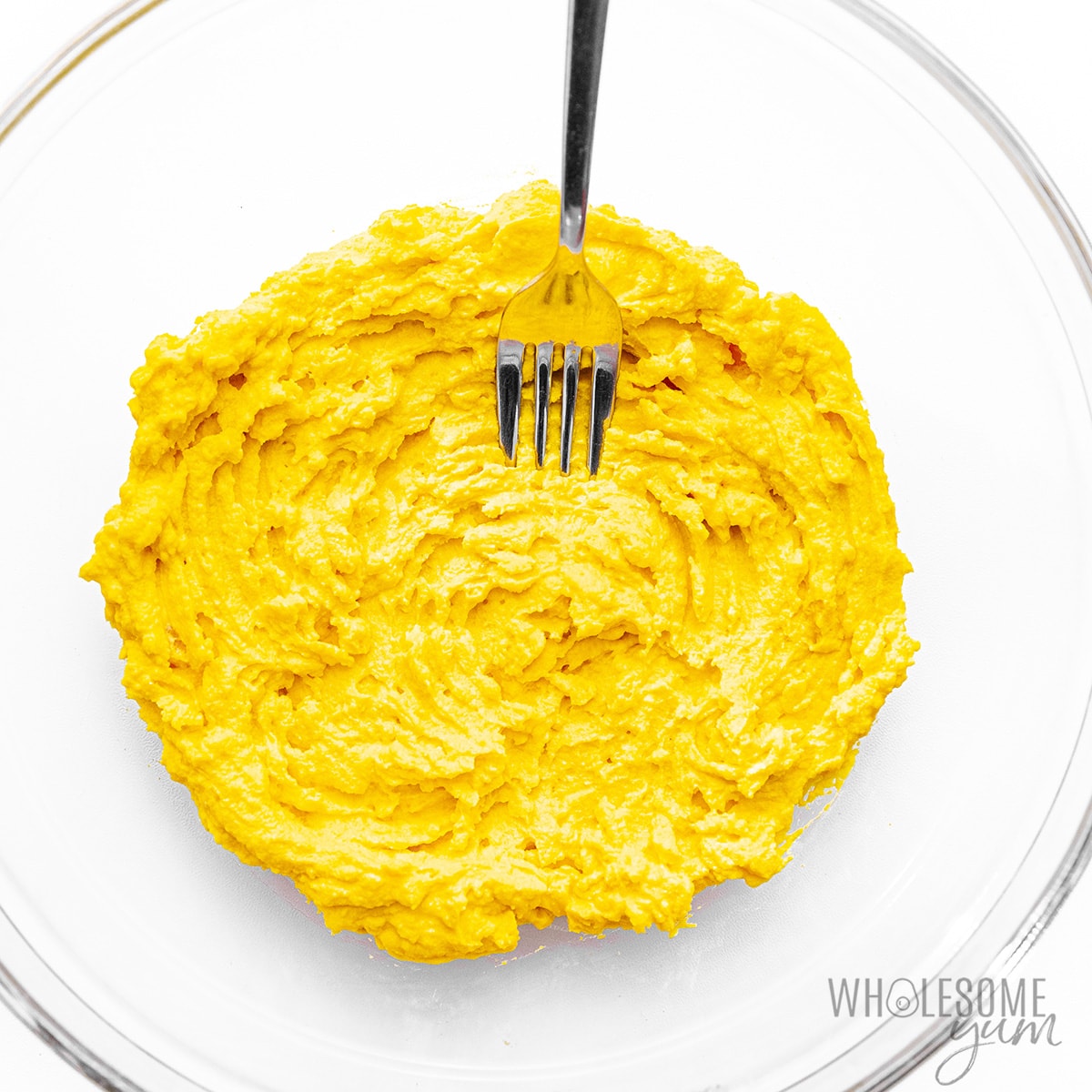 Yolks mixed with mayo and other ingredients in a bowl.