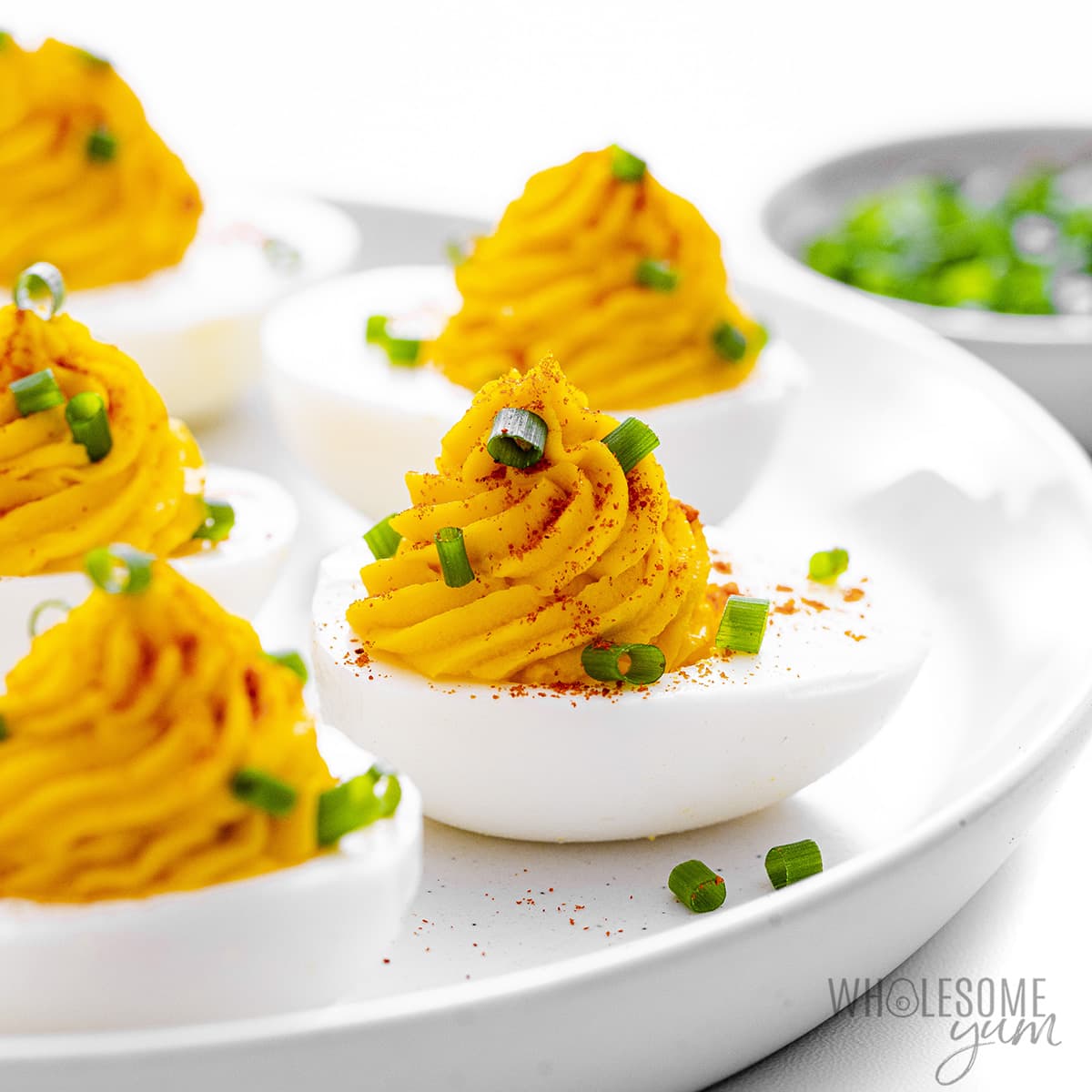 The best deviled eggs topped with paprika and chives.